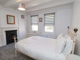 A bedroom with a bed and mirror at The Anchorage in Whitby