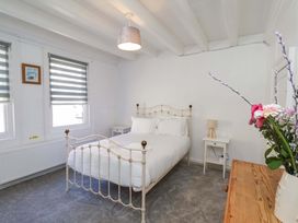 A bedroom with a bed and nightstand at The Anchorage in Whitby