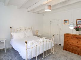 A bedroom with a bed and dresser at The Anchorage in Whitby