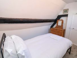 A bedroom with a bed and mirror at The Anchorage in Whitby