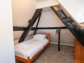 A bedroom with a bed and wooden furniture at The Anchorage in Whitby