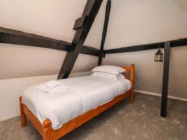 A bedroom with a wooden bed and lantern at The Anchorage in Whitby