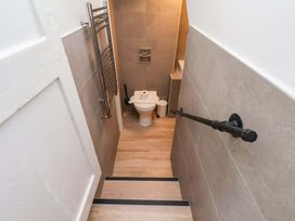 A bathroom with a toilet and towel rack at The Anchorage in Whitby
