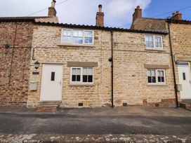 A stone cottage exterior with windows and a door at Dunning, The Mount in York