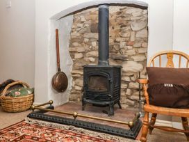 A living room featuring a stove and stone wall at Dunning, The Mount, York