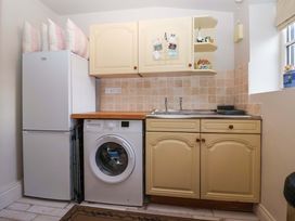A laundry room with a refrigerator and washing machine at Dunning, The Mount, York
