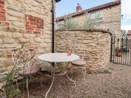 A garden area with a table and chairs at Dunning, The Mount in York