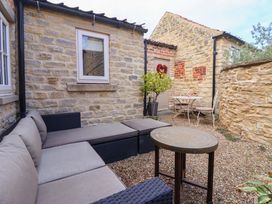 An outdoor seating area with a table and chairs at Dunning, The Mount in York