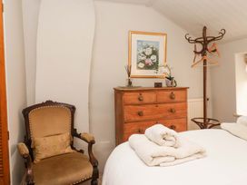 A bedroom with a dresser, bed, chair, and painting at Dunning, The Mount, York