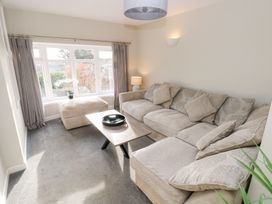 A living room with a sofa and coffee table at Westwinds in Tenby