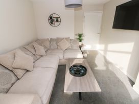 A living room with a sofa and coffee table at Westwinds in Tenby