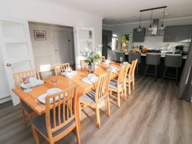 A dining room with a table set for dinner at Westwinds in Tenby