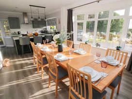 A dining room with a table set for dinner at Westwinds in Tenby