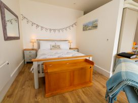 A bedroom with a bed and side tables at 4 The Beaches in Weymouth