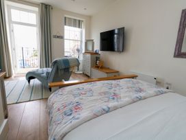 A bedroom with a bed and television at 4 The Beaches in Weymouth