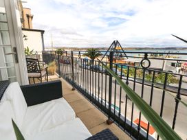 A balcony with chairs and a view of the sea at 4 The Beaches in Weymouth