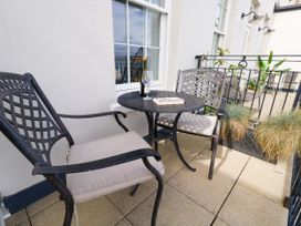 A balcony with two chairs and a table at 4 The Beaches in Weymouth