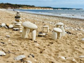 Stone structures on a beach with a coastline and water in the background at Bobbies Retreat, 20 High Street, Bridlington