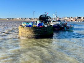 A fishing port with boats and containers at Bobbies' Retreat, 20 High Street, Bridlington