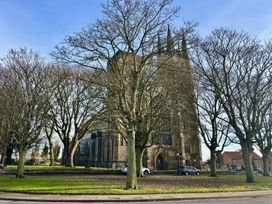 A church surrounded by trees and cars at Bobbies Retreat, 20 High Street, Bridlington