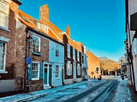 A street scene with historic buildings and road signs at Bobbies Retreat, 20 High Street Bridlington