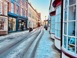 A street view with buildings and snow at Bobbies' Retreat, 20 High Street Bridlington