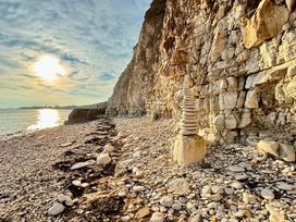 A beach scene with a rock stack and cliffs at Bobbies Retreat, 20 High Street, Bridlington