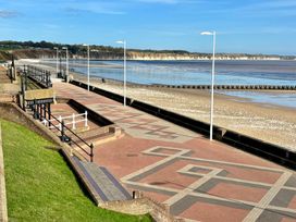 A beach with a promenade and lighting poles at Bobbies' Retreat, 20 High Street, Bridlington