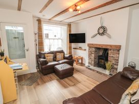 A living room with sofas and a coffee table at Bobbies' Retreat, 20 High Street in Bridlington