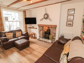 A living room with a sofa and television at Bobbies' Retreat, 20 High Street Bridlington