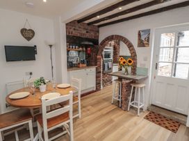 A kitchen with dining table and chairs at Bobbies Retreat, 20 High Street in Bridlington