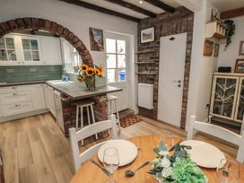 A kitchen with a table and chairs at Bobbies Retreat, 20 High Street in Bridlington