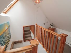 A hallway with a staircase and a side table at Bobbies' Retreat, 20 High Street