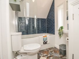 A bathroom with a shower, bathtub, and sink at Bobbies' Retreat, 20 High Street, Bridlington