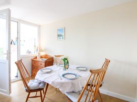 A dining room with a table set for four at Merlin in Malborough
