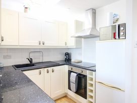 A kitchen with cabinets and appliances at Merlin in Malborough