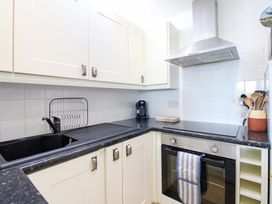 A kitchen with a sink, stove and coffee machine at Merlin in Malborough