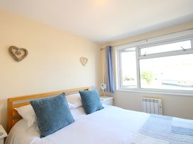 A bedroom with a bed and window at Merlin in Malborough