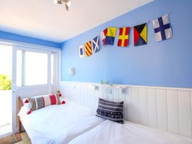 A bedroom with two beds and flag decorations at Merlin in Malborough