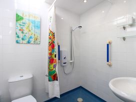 A bathroom with a toilet, shower, and sink at Merlin in Malborough