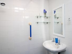 A bathroom with a sink and mirror at Merlin in Malborough