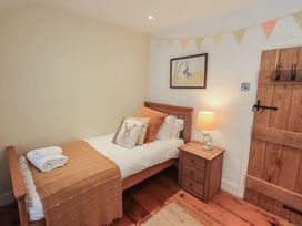 A bedroom with a single bed and bedside table at Green Stile Cottage in Bowness-On-Windermere