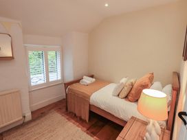 A bedroom with a bed and window at Green Stile Cottage Bowness-On-Windermere