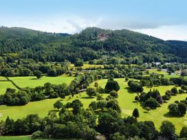 A landscape view of a golf course surrounded by trees at Greffyn in Betws-Y-Coed