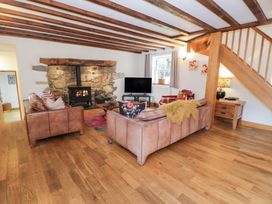 A living room with a fireplace and television at Greffyn in Betws-Y-Coed