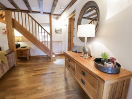 An entrance hall with a console table and staircase at Greffyn in Betws-Y-Coed