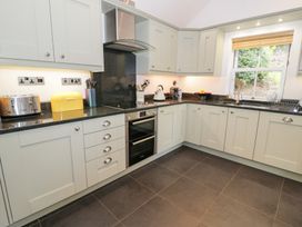 A kitchen with appliances and cabinets at Greffyn in Betws-Y-Coed