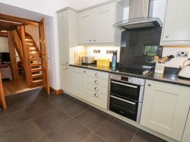 A kitchen with cabinets and appliances at Greffyn in Betws-Y-Coed
