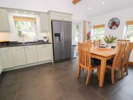 A kitchen with a table and chairs at Greffyn in Betws-Y-Coed