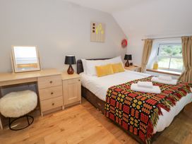A bedroom with a bed and desk at Greffyn in Betws-Y-Coed